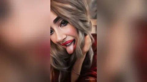 Smiling blonde woman in a red outfit making a playful expression in a soft-lit indoor setting.