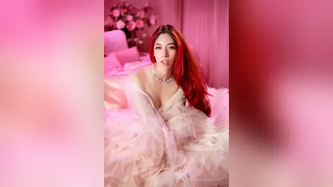 Red-haired woman in a voluminous pink ruffled gown sitting in a dreamy, romantic pink bedroom setting.