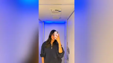 VeronicaValdez takes a mirror selfie wearing a black zip-up sweatshirt with her long dark hair down.