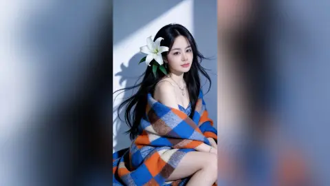 Elegant woman with long dark hair and a white lily flower wrapped in a blue and orange plaid blanket.