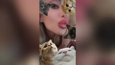 Playful woman making a kissing face surrounded by several cute kittens in a cozy, whimsical mood.