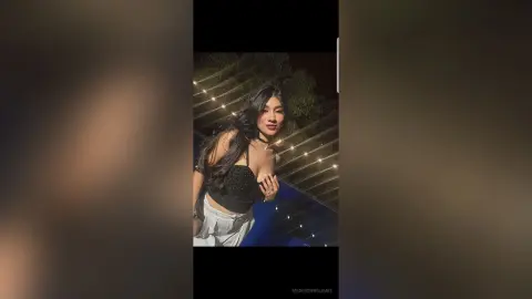 MadiisonWilliams poses outdoors at night wearing a black lace bra and white pants, with long dark hair and a black choker.