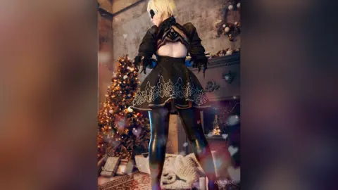 AvaLindt poses from behind in a black lace outfit and shiny black leggings, standing in front of a lit Christmas tree.