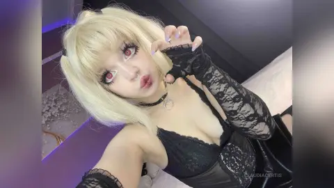 Blonde anime girl in black lace goth outfit with red eyes posing in a moody bedroom setting.