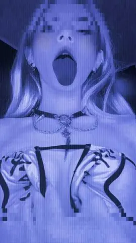 Moody blue aesthetic portrait of a woman in a white crop top and black choker necklace.