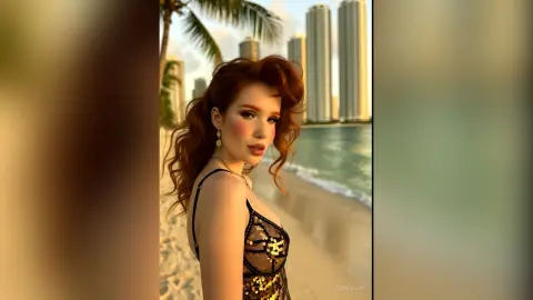 Redheaded woman in a black sequin dress posing on a sunny tropical beach with city skyscrapers in the background.
