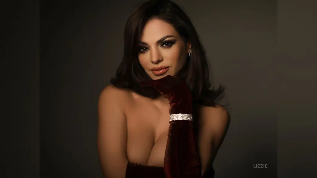 Young woman in a red off-the-shoulder top posing at night with a city skyline background.