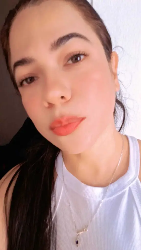 SweetSquiirtxxx has long dark hair and a neutral expression, looking directly at the camera in a close-up shot.