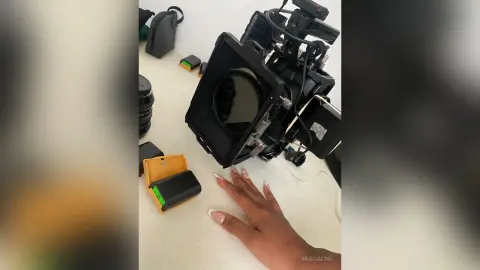 Professional cinema camera equipment and accessories on a white studio table for film production.
