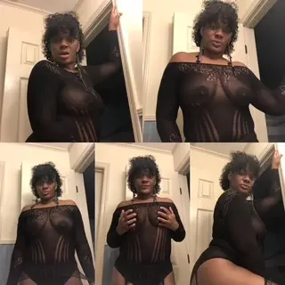 VeraMonae — Curvy woman in a sheer black long-sleeve bodysuit posing confidently in a bedroom setting.