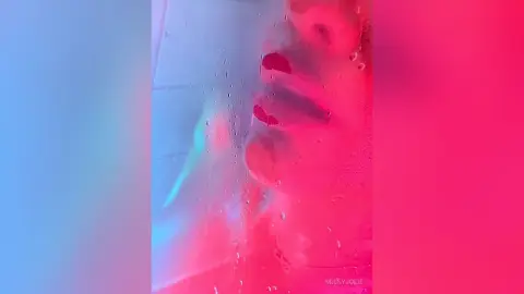 MissyJolie's face is pressed against a wet, translucent surface with pink and blue lighting, showing her lips and nose through water droplets.