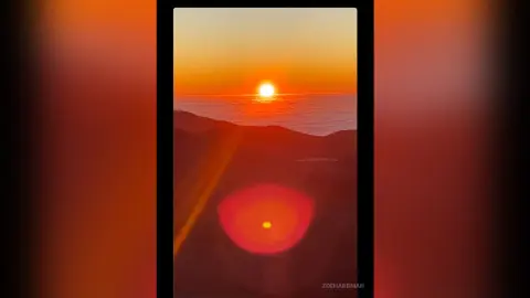 Golden sunset over a vast ocean horizon creating a peaceful and warm atmospheric mood.
