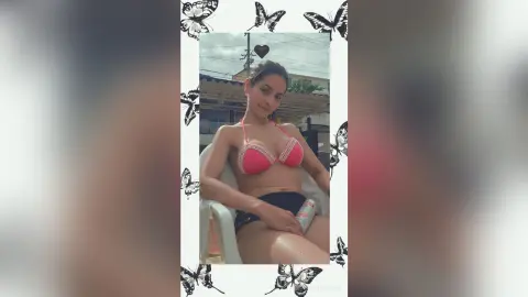 Young woman in a pink bikini relaxing outdoors on a sunny day with a butterfly frame decoration.