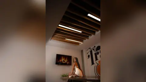 Elegant woman in a white dress sitting in a modern minimalist room with warm ambient lighting.