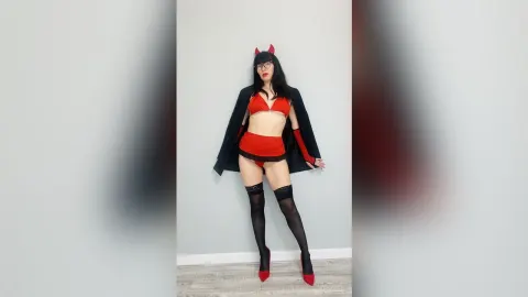 ViolaWin — ViolaWin poses in a red devil costume with horns, a red bra and skirt, and black thigh-high stockings.