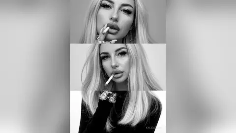 Glamorous blonde woman in a black outfit with long nails posing for a moody black and white portrait.