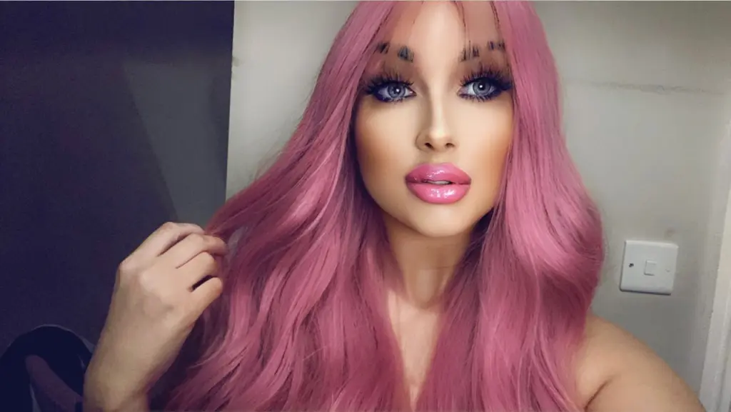 BlondieBarbieBabe poses for a close-up selfie, showing her blonde hair and light eyes while looking directly into the camera.