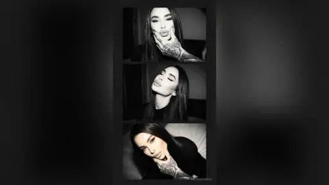 ReynaGomes poses in black and white, showing her long dark hair, tattoos, and lips in a close-up shot.