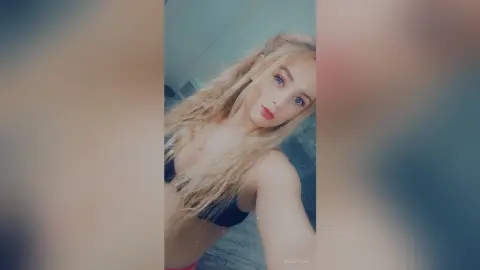 Blonde woman in black bikini top posing for a close-up portrait with a soft, dreamy aesthetic.