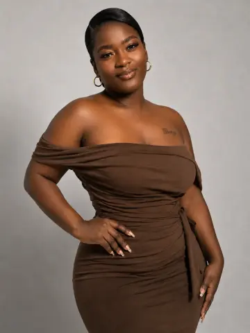 Elegant Black woman in a brown off-the-shoulder cocktail dress posing against a neutral studio background.