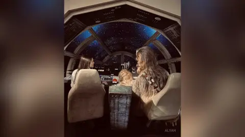 Two women sitting in a futuristic spaceship cockpit looking out at a starry night sky in a cinematic mood.