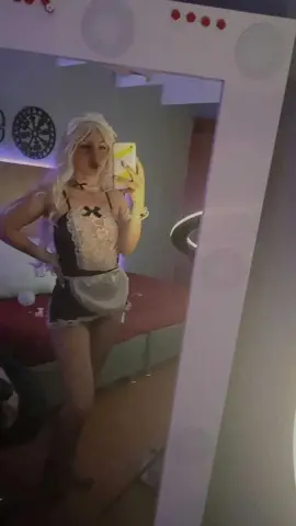 ScarlettGV poses in a white and black lace maid outfit with a white headband, holding a yellow phone for a mirror selfie.