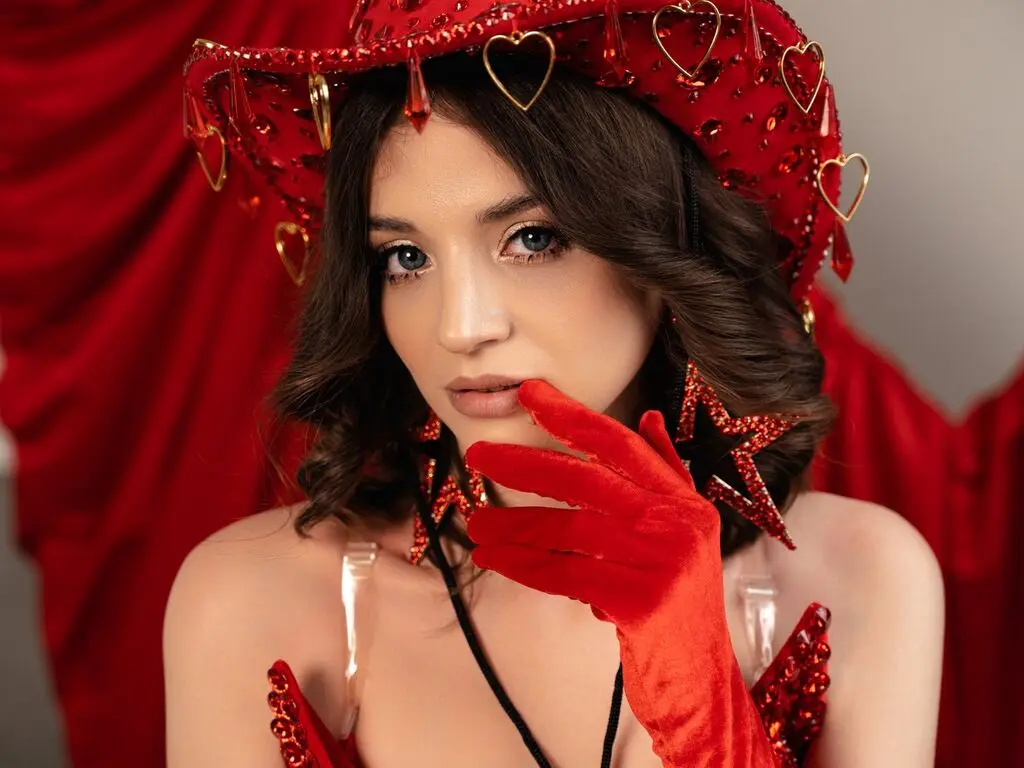 Glamorous woman in red velvet star accessories and gloves posing against a festive red backdrop.