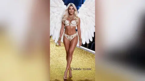 JessycaPage poses in white angel wings and a sparkly gold bikini set on a glittery runway.
