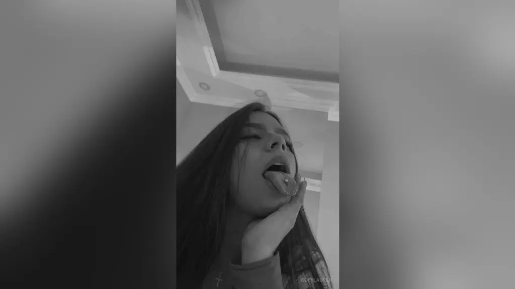 SofyLauren — Moody black and white portrait of a young woman with long hair posing indoors.