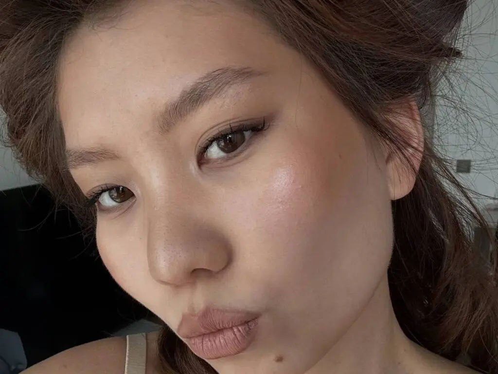 JamieRamirez pouts her lips in a close-up selfie, showing her face and dark hair against a plain background.