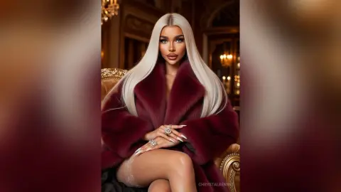 Glamorous blonde woman in a luxurious burgundy faux fur coat sitting in an elegant, moody interior setting.
