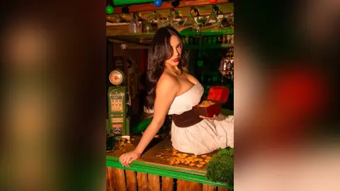 Glamorous woman in a white strapless dress holding a gold box in a moody, vintage bar setting.