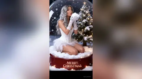 Elegant woman in white lace outfit inside a magical Christmas snow globe with a festive holiday mood.