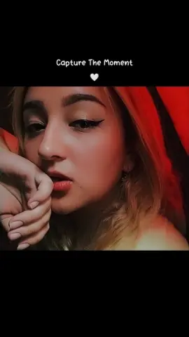 Katiee_and_sharon looks into the camera with winged eyeliner and red lipstick, resting her chin on her hand.