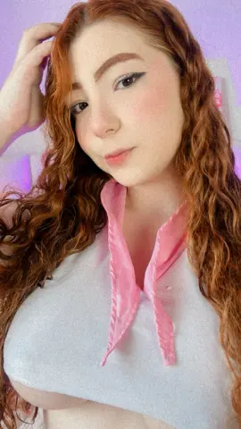 Redheaded woman in a white halter top and pink scarf posing with a soft, dreamy aesthetic.