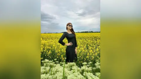 JennyStormy — Lady in black in a rapeseed field