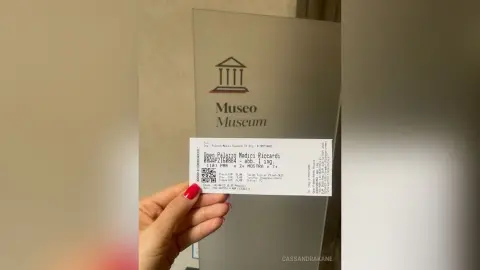 A hand holding a museum entrance ticket for the Museo Palazzi Medici Riccardi in Florence, Italy.