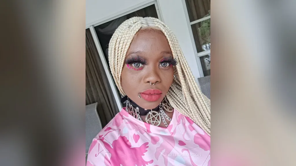AkeliaHampson with long blonde braids and dramatic eyelashes poses for a close-up selfie.