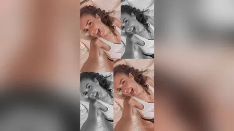 MontseFerrera smiles while lying on her back, sticking her tongue out and wearing a white sports bra.