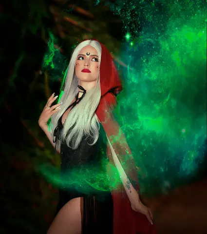 AlicceGray poses in a red hooded cloak and black lace bodysuit, surrounded by glowing green smoke or magical light effects.