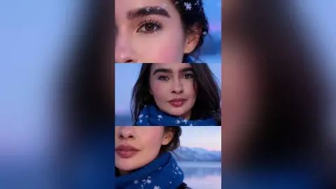 Young woman with snowflake makeup wearing a blue winter scarf in a soft, dreamy twilight setting.