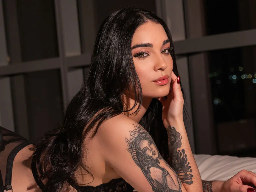 Woman with curly hair in black bra, head tilted back near window, natural light, intimate mood
