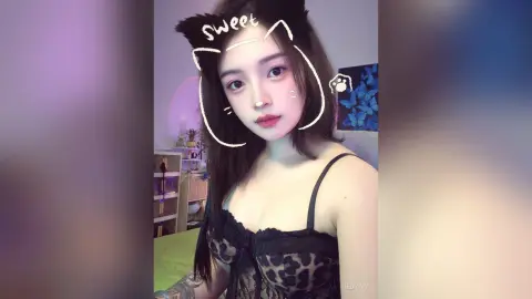HedyIvy wearing a black lace leopard print camisole, looking at the camera with long dark hair and a cat-ear filter overlay.