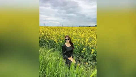 JennyStormy — Lady in black in a rapeseed field
