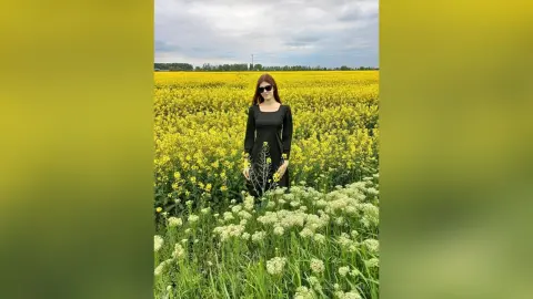 JennyStormy — Lady in black in a rapeseed field