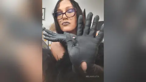 Woman in gothic black outfit and gloves wearing dark glasses with a moody aesthetic.