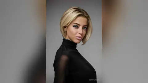 Elegant blonde woman in a black turtleneck posing against a neutral studio background with a sophisticated mood.