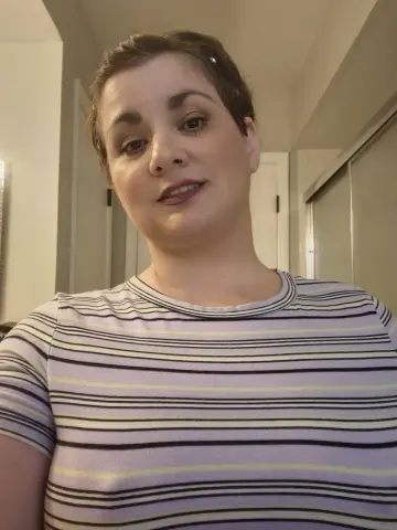 RicanShy wearing a striped t-shirt, looking directly at the camera with short brown hair in an indoor setting.