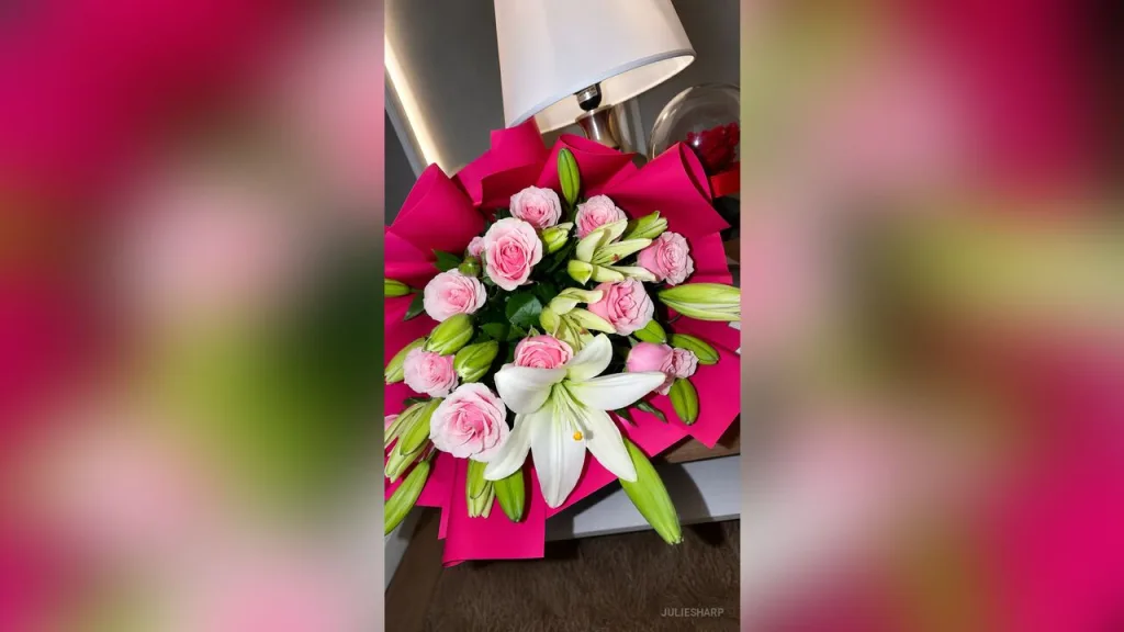 JulieSharp — JulieSharp presents a large bouquet of pink roses and white lilies wrapped in bright pink paper.