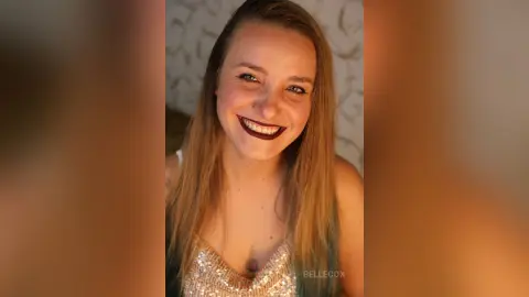 Smiling blonde woman in a sparkling gold sequin top posing indoors with a joyful mood.
